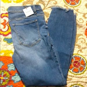 Sneak peek jeans with frayed bottom. NWT